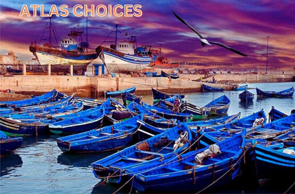 Blue fishing boats docked in the harbor with a fish market nearby in Essaouira.