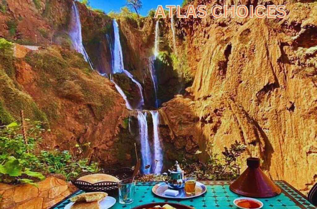 Traditional Berber tagine served on a rooftop with a stunning view of Ouzoud Waterfalls.