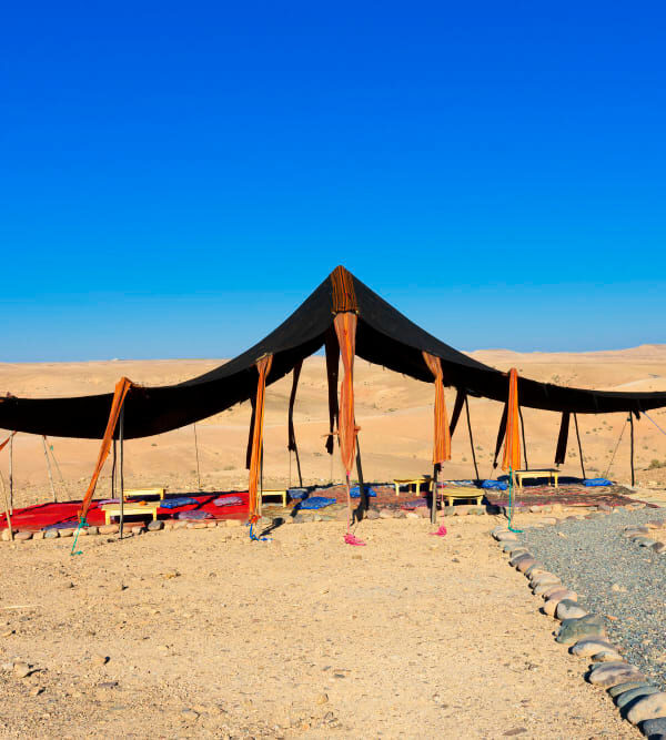 The rocky landscapes of Agafay Desert, located near Marrakech, with camel rides and stunning sunset views.